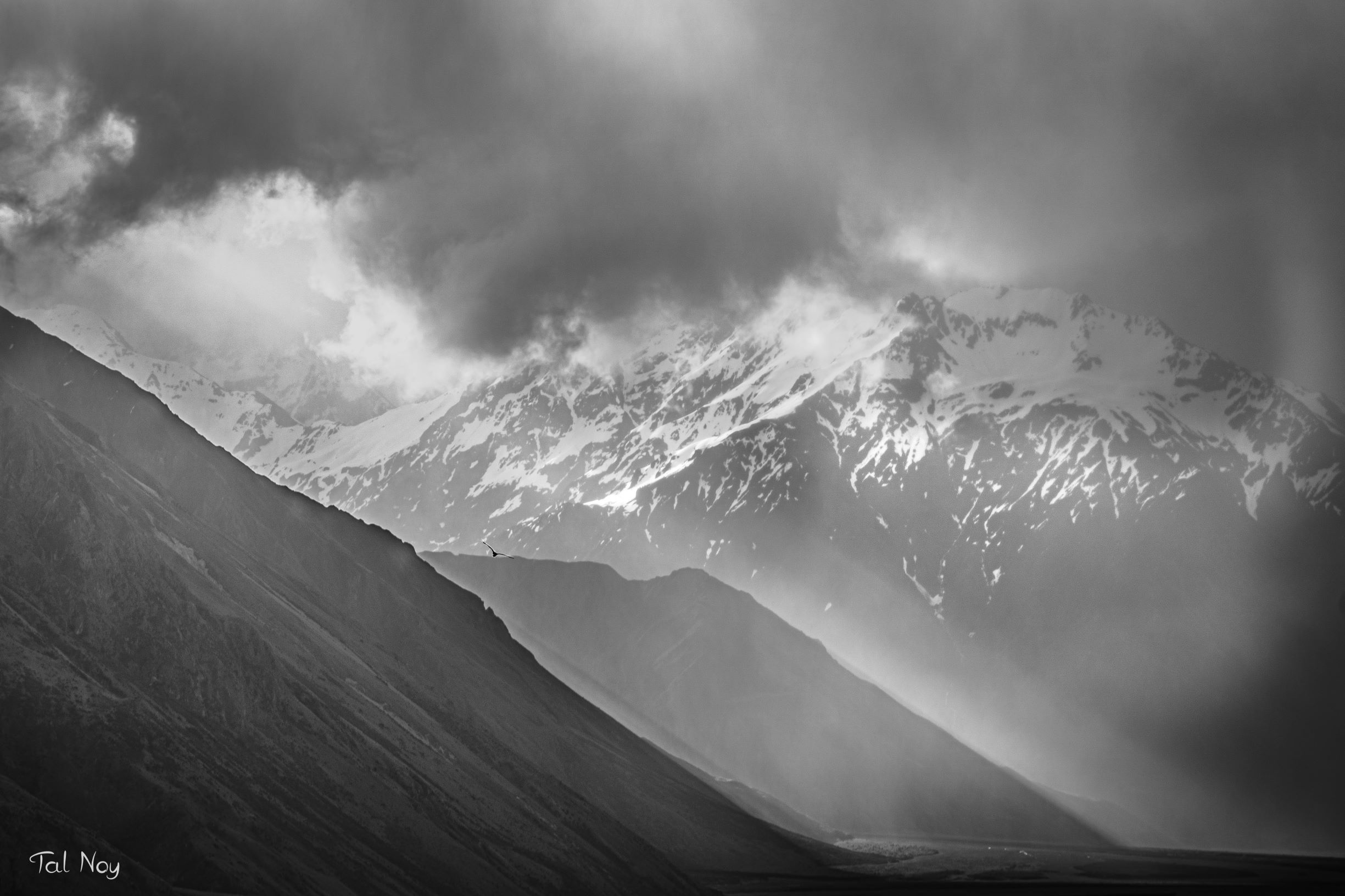 Dramatic light rays piercing through clouds at sunset near Mount Sunday, South Island, New Zealand
